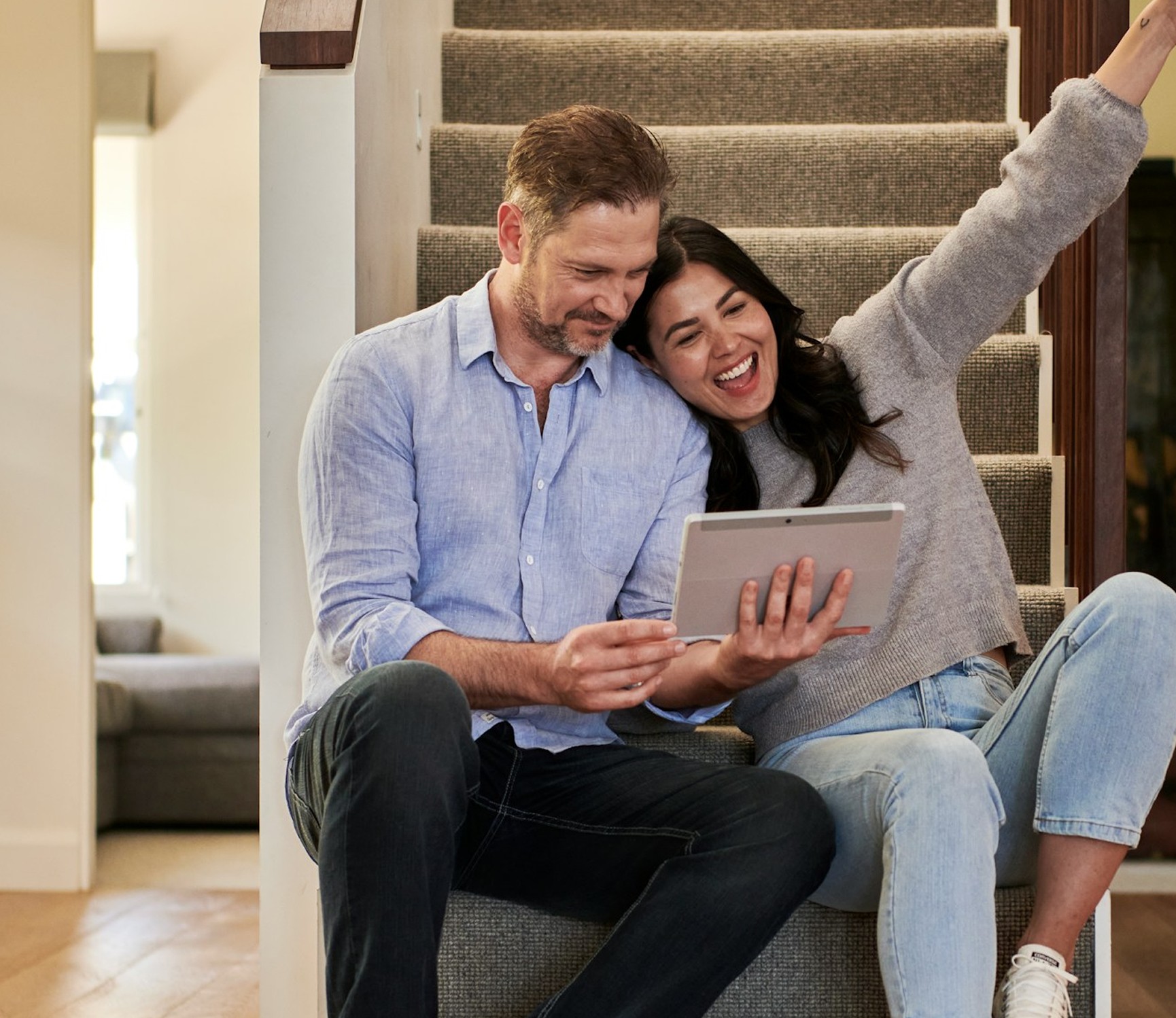 Couple excited looking at the tablet