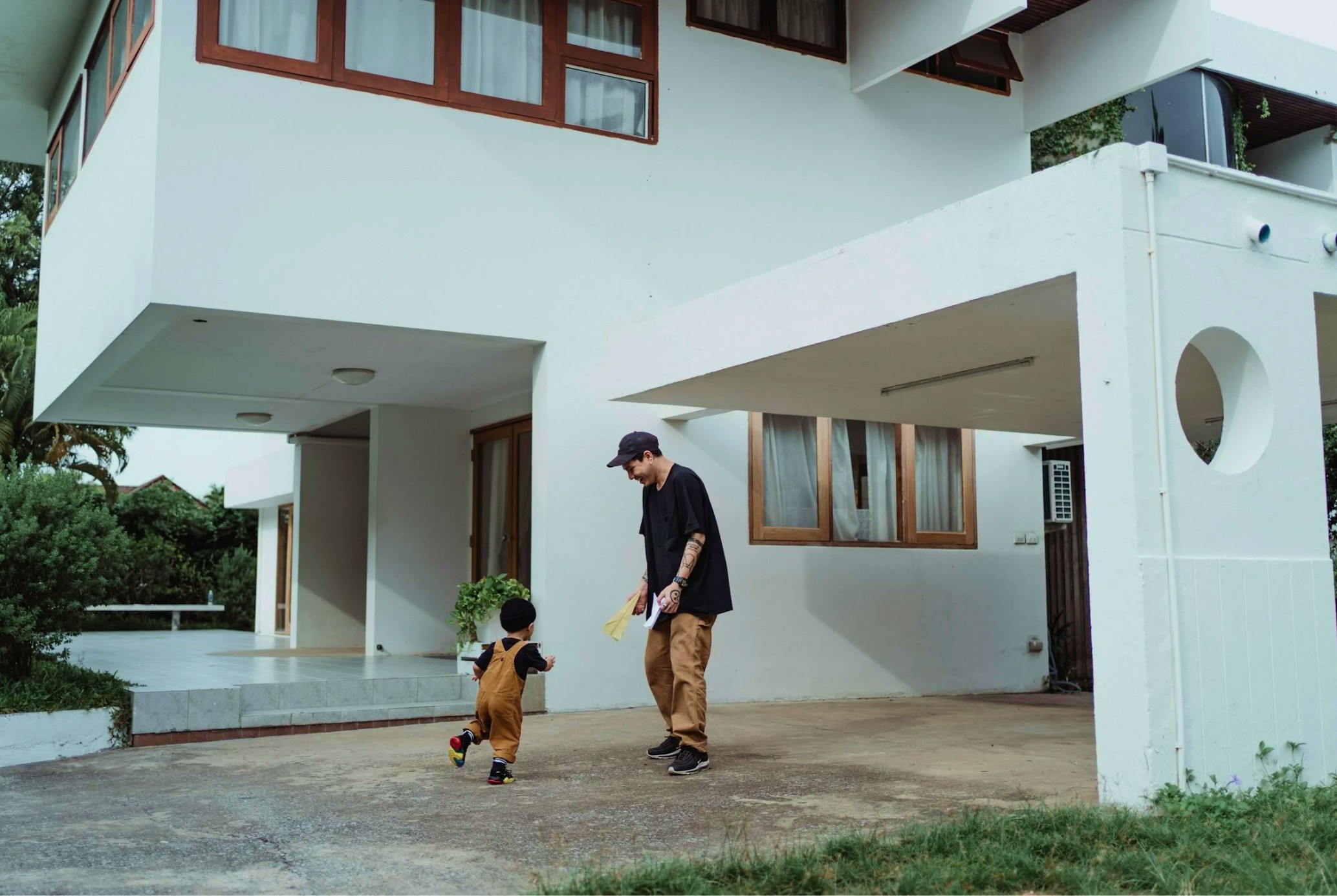 Dad playing with child in front of the house